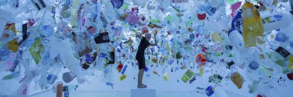 image of person surrounded by trash for trash art